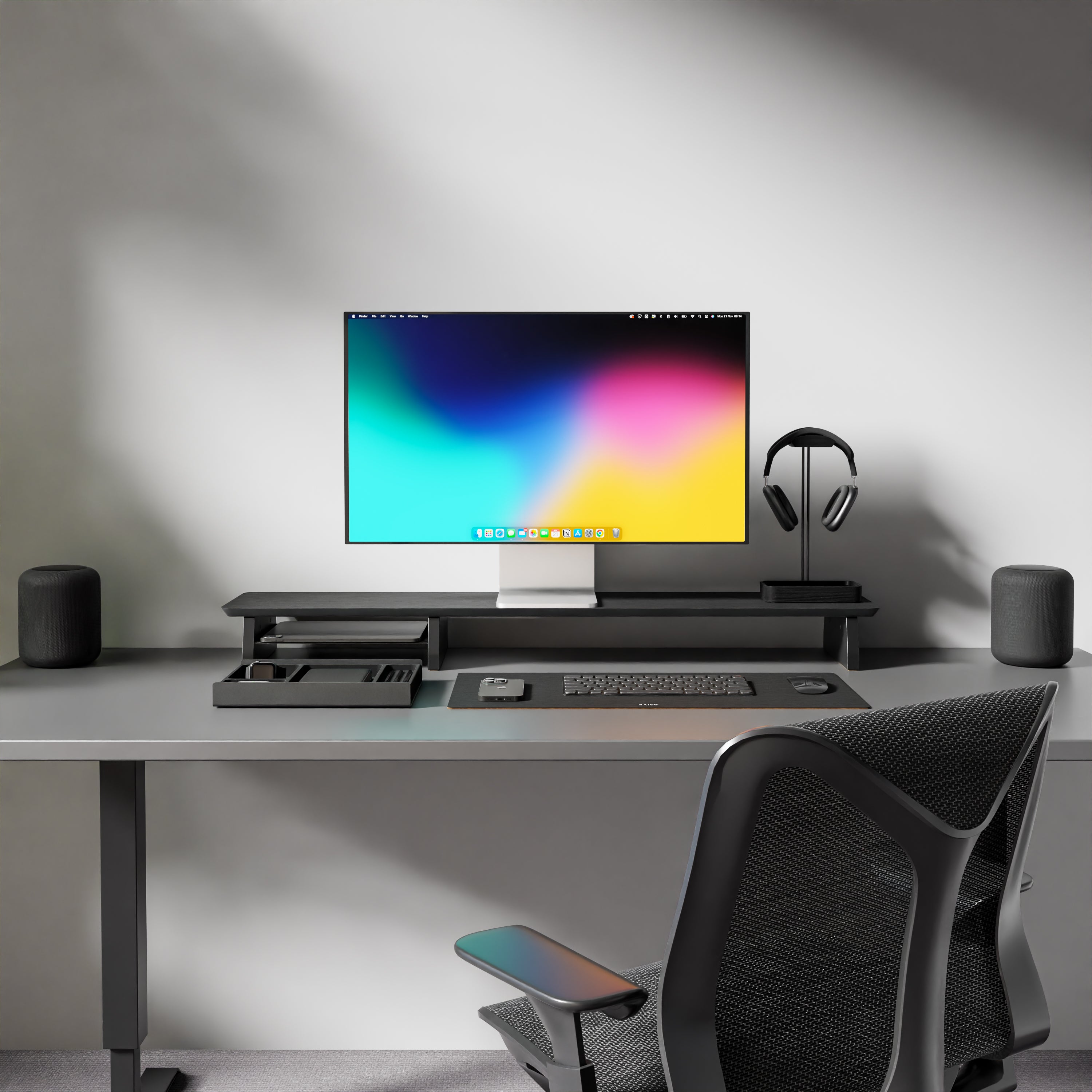 minimal desk setup featuring a desk shelf for monitor, headphone stand, and desk mat. The desk shelf elevates the monitor to the ideal viewing height, improving ergonomics and reducing neck strain. The headphone stand helps keep your desk clutter-free, and the desk mat adds a touch of style while protecting your desk surface. If you're looking for a grovemade alternative, these simple yet effective accessories are a great option. Upgrade your workspace with these must-have desk accessories.